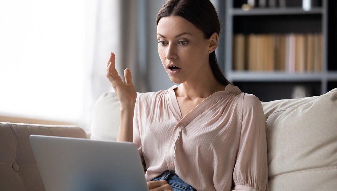 Shocked young woman with open mouth looking with amazement at laptop screen, reading unexpected news in message, surprised by message or email, watching video in social network or movie